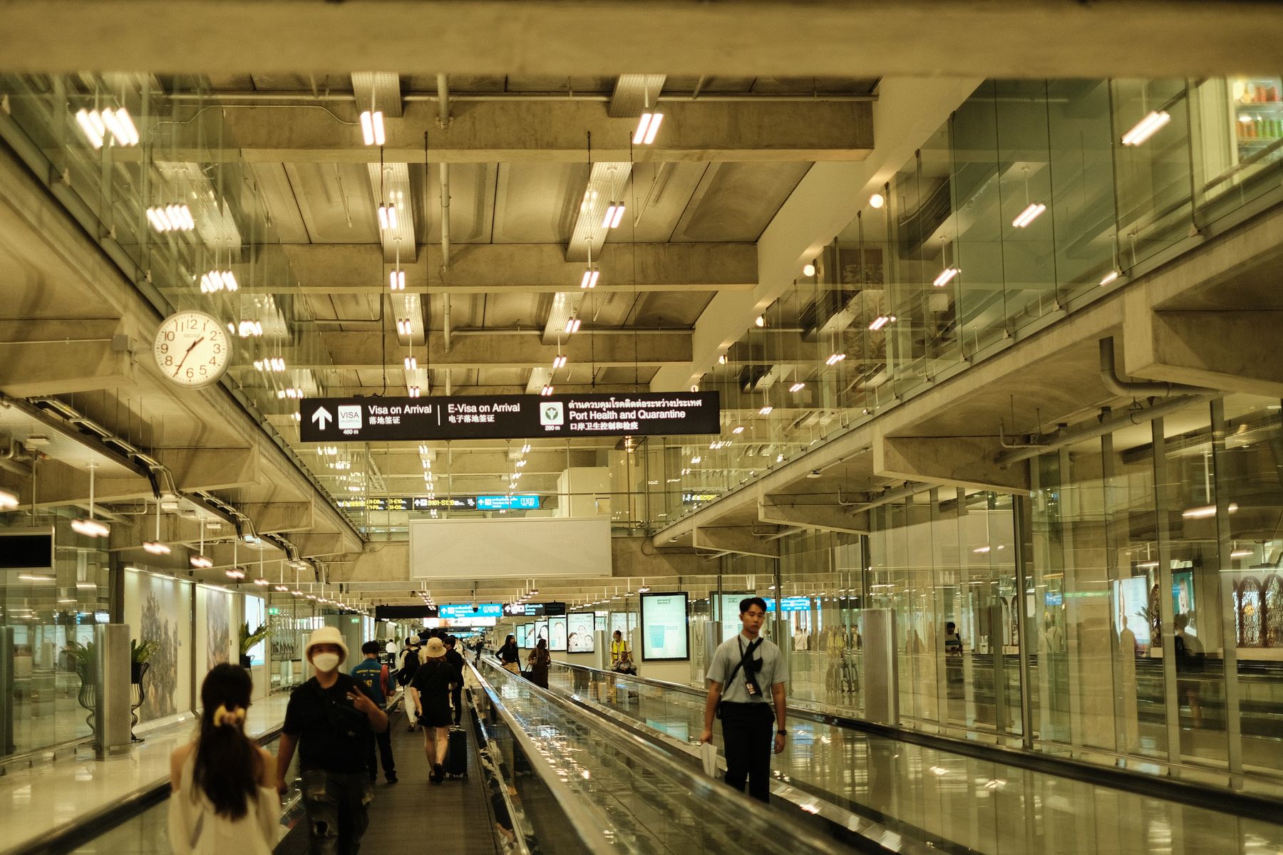 Travellers walking through a bright modern international airport terminal