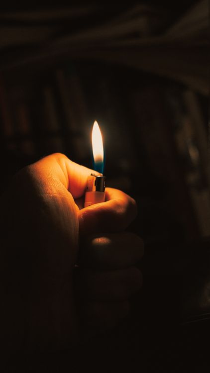 Hand Holding Lighter in Darkness · Free Stock Photo