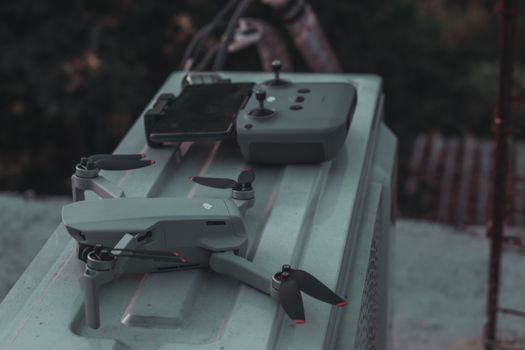 A close-up of a compact drone and its controller, highlighting modern technology and innovation.