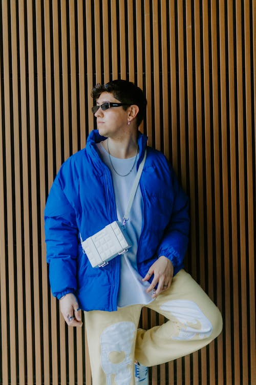 Young Man in a Blue Winter Jacket and Sunglasses