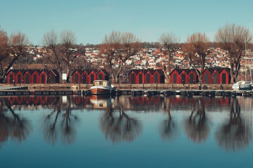 A Row of Red Huts on a Lakeshore 