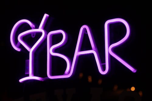 Close-up of a Purple Neon Sign of a Bar