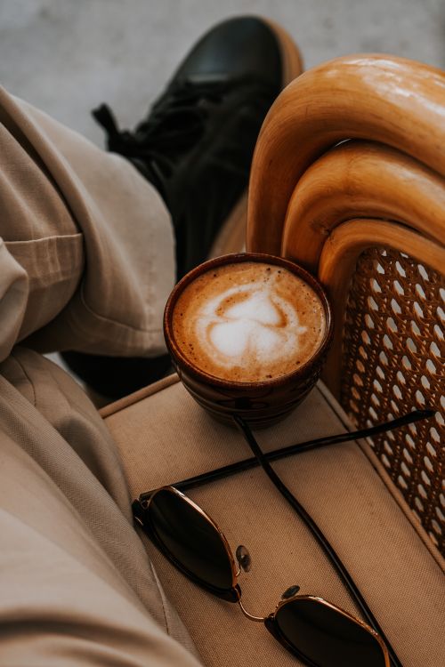 Free Cappuccino on a chair with sunglasses, capturing a relaxed moment in Ankara, Türkiye. Stock Photo