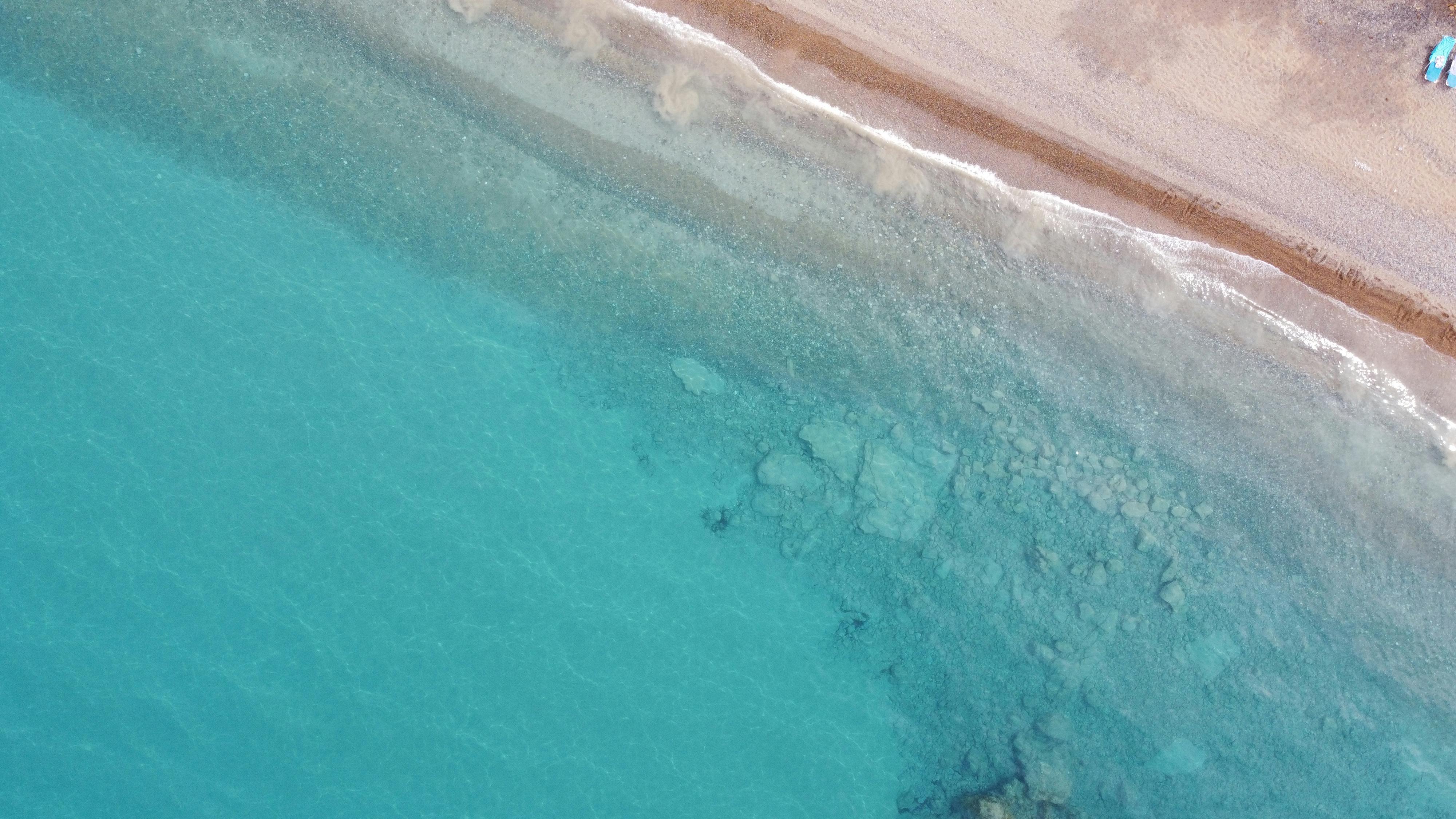 Drone shot showing the clear turquoise waters and sandy shore of Neo Chorio, Cyprus. - Photo by Adrian Gyuris on Pexels