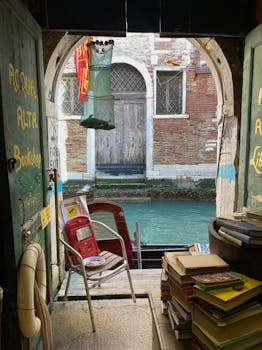 Explore a charming bookstore in Venice, Italy, with a serene canal view.