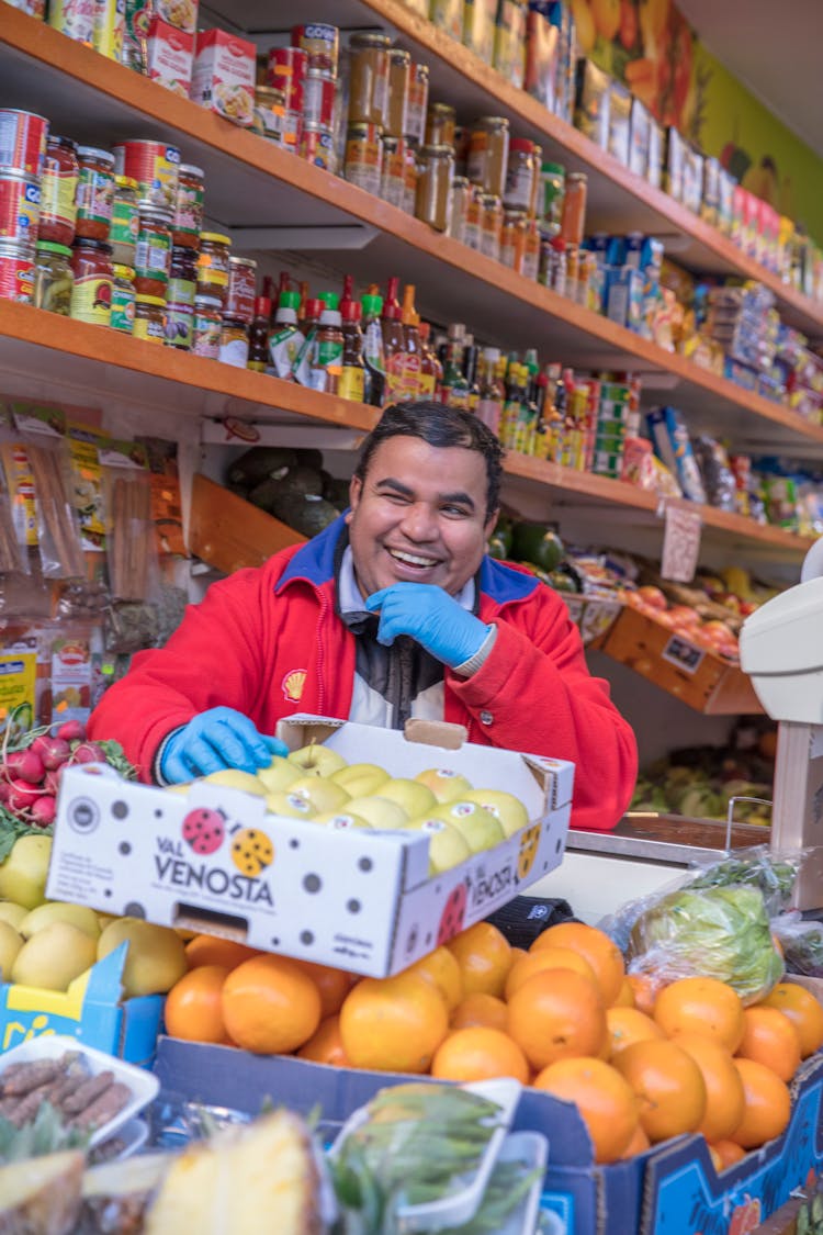 Cheerful Man Working In Grocery Store