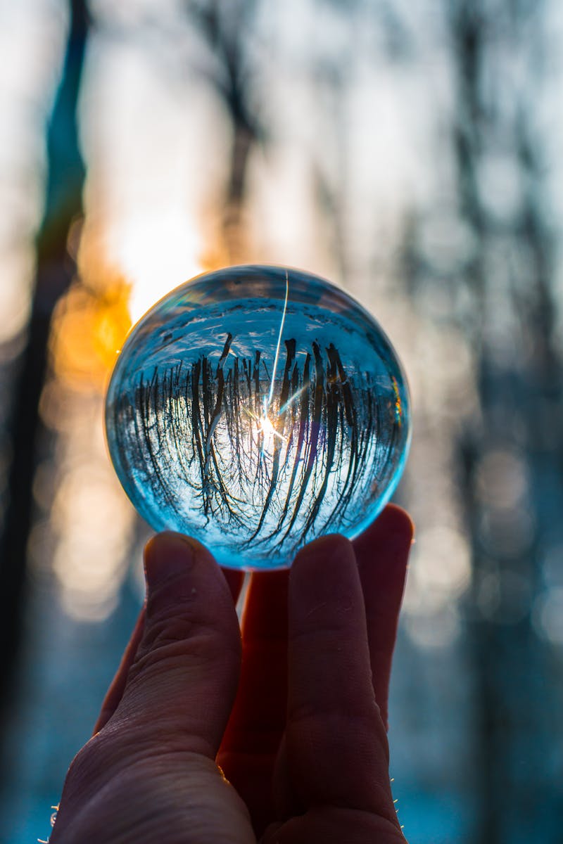 Photo of Person Holding Crystal Ball