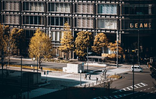 Free Aerial view of Tokyo streets with pedestrians and urban architecture under sunlight. Stock Photo
