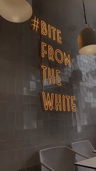 Stylish café interior in Istanbul featuring a modern neon sign and contemporary furniture.