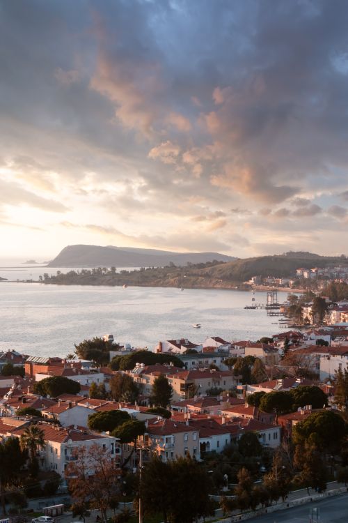 Free Stunning panoramic view of Izmir's coastline at sunset, featuring the tranquil sea and vibrant urban landscape. Stock Photo
