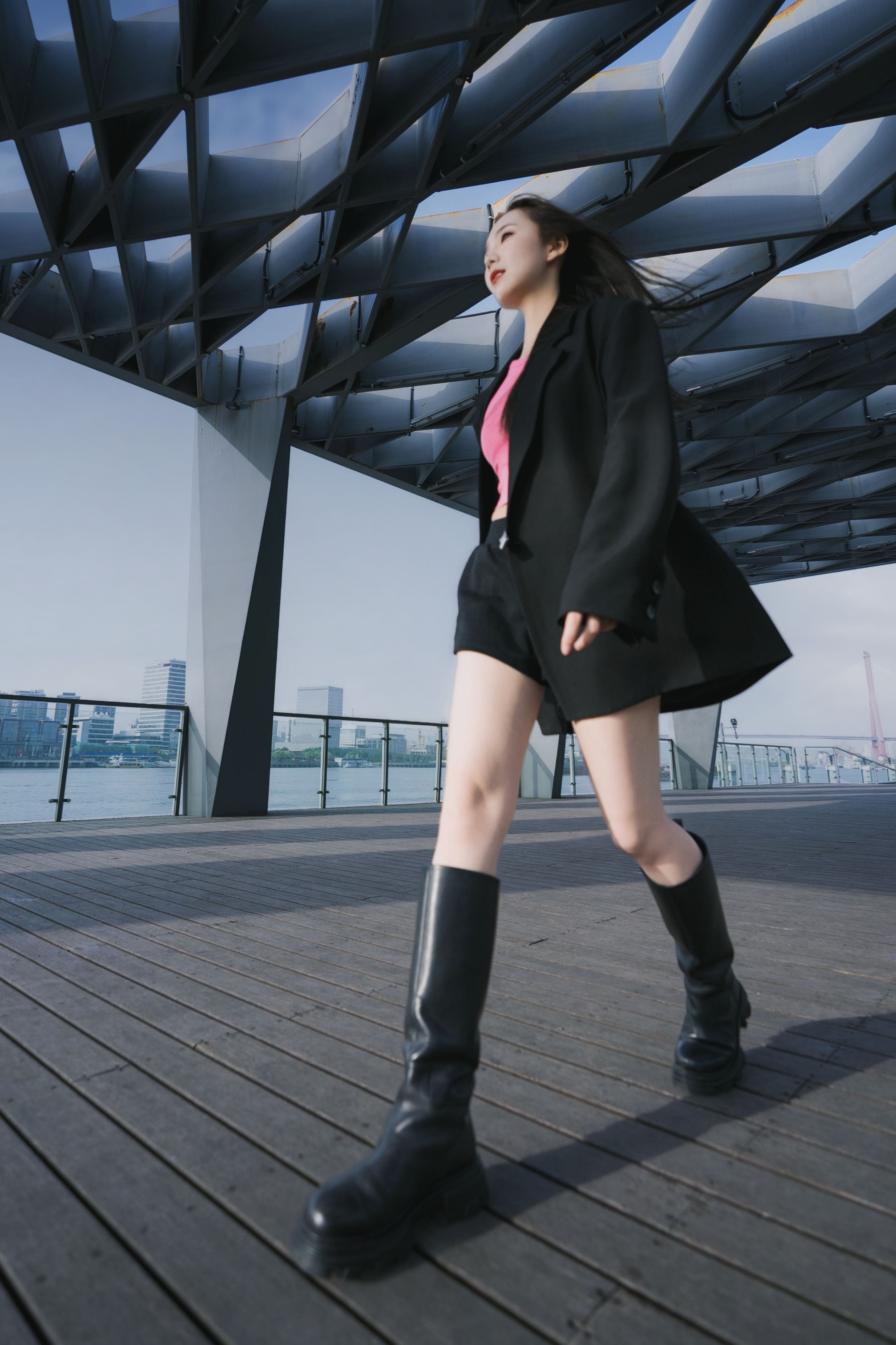 Woman in Black Suit Jacket Walking on Promenade · Free Stock Photo