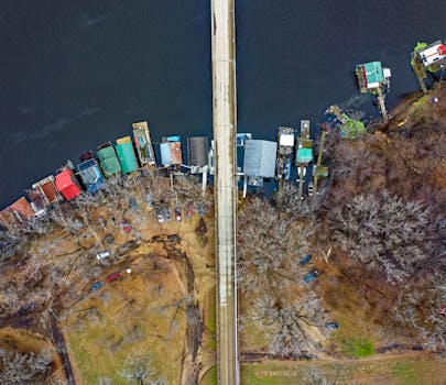 Drone shot capturing a bridge and colorful riverside houses in Winona, MN.
