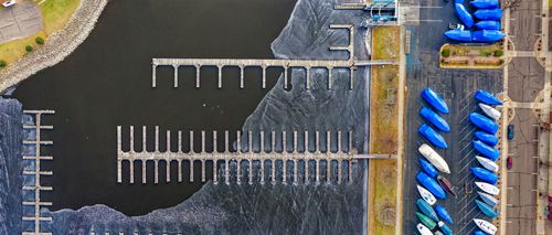 Free Overhead view of marina docks and covered boats at Lake City, highlighting the nautical landscape. Stock Photo