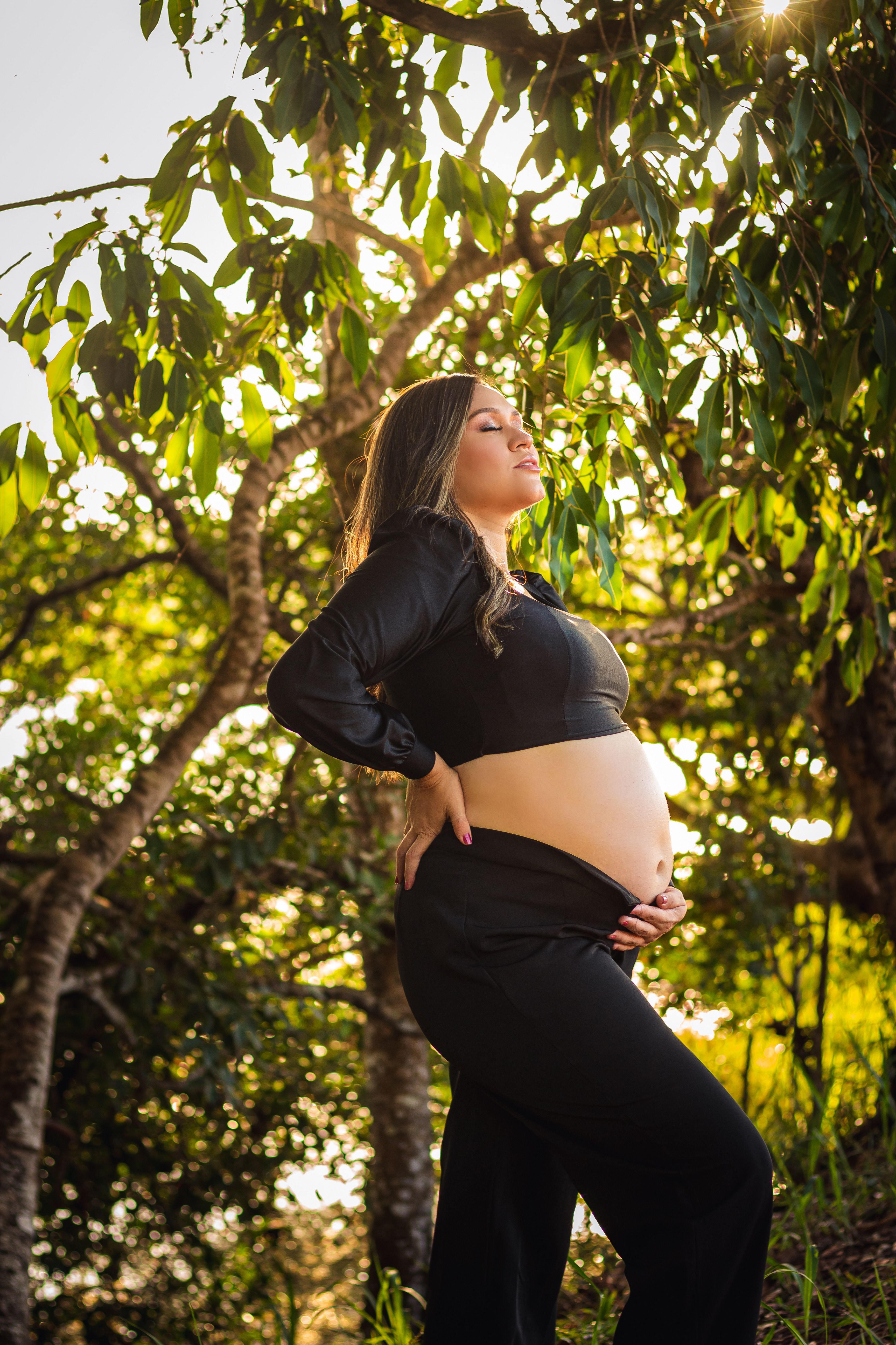 Pregnant Woman Posing against Trees · Free Stock Photo