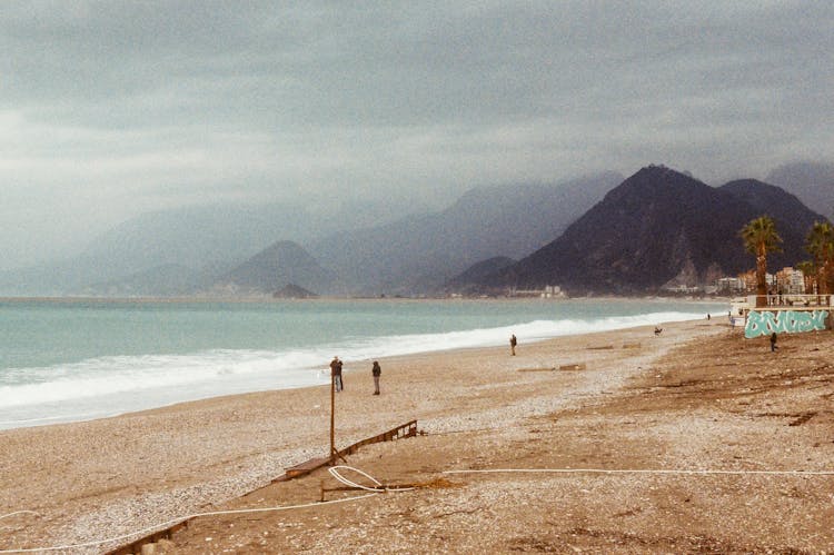 People On Beach During Storm