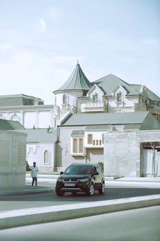 A sleek black car parked in front of an ornate historical building with unique architectural design.