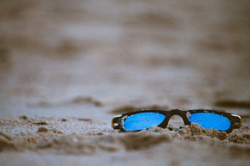 Black Framed Sunglasses On Sand