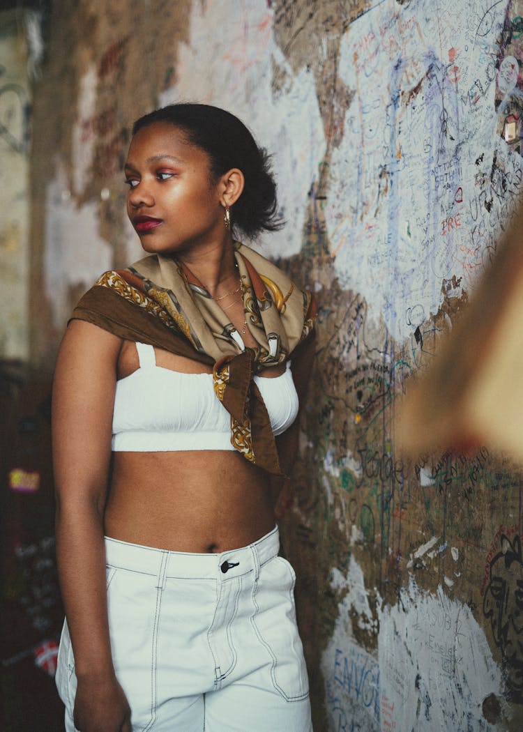 Young Woman In A White Tank Top And Pants 