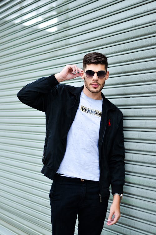 Man in Sunglasses Posing by Wall