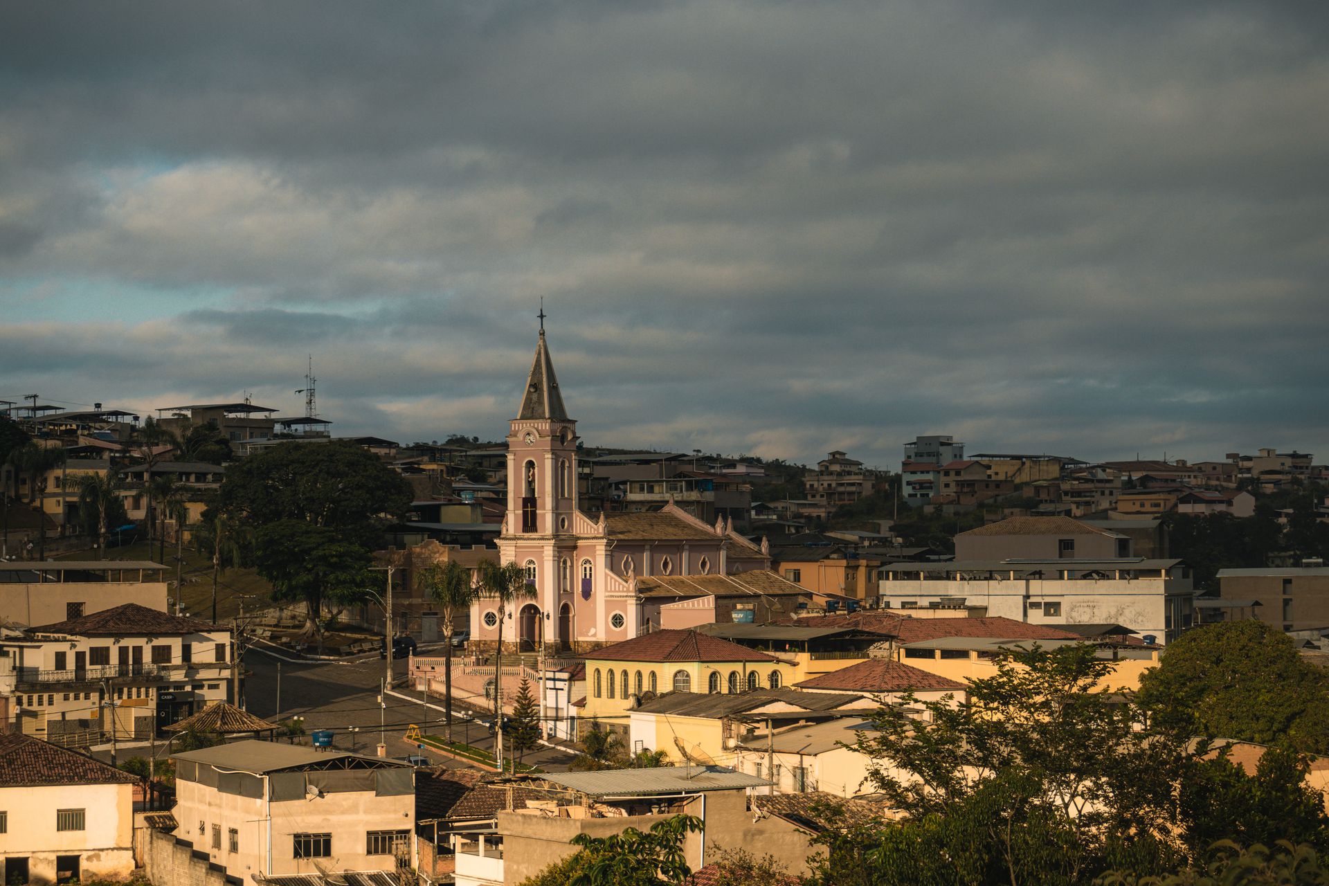 Scenic view of a traditional church in Dores de Campos, Brazil, under cloudy skies.