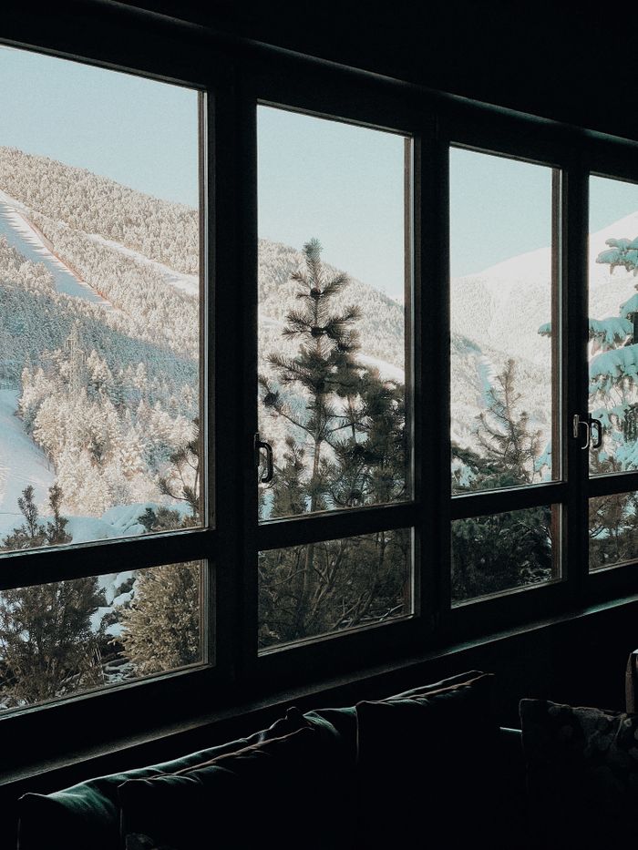 Snow-covered mountains seen from an indoor window