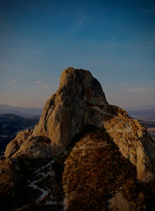 Free A mountain with a large rock on top Stock Photo