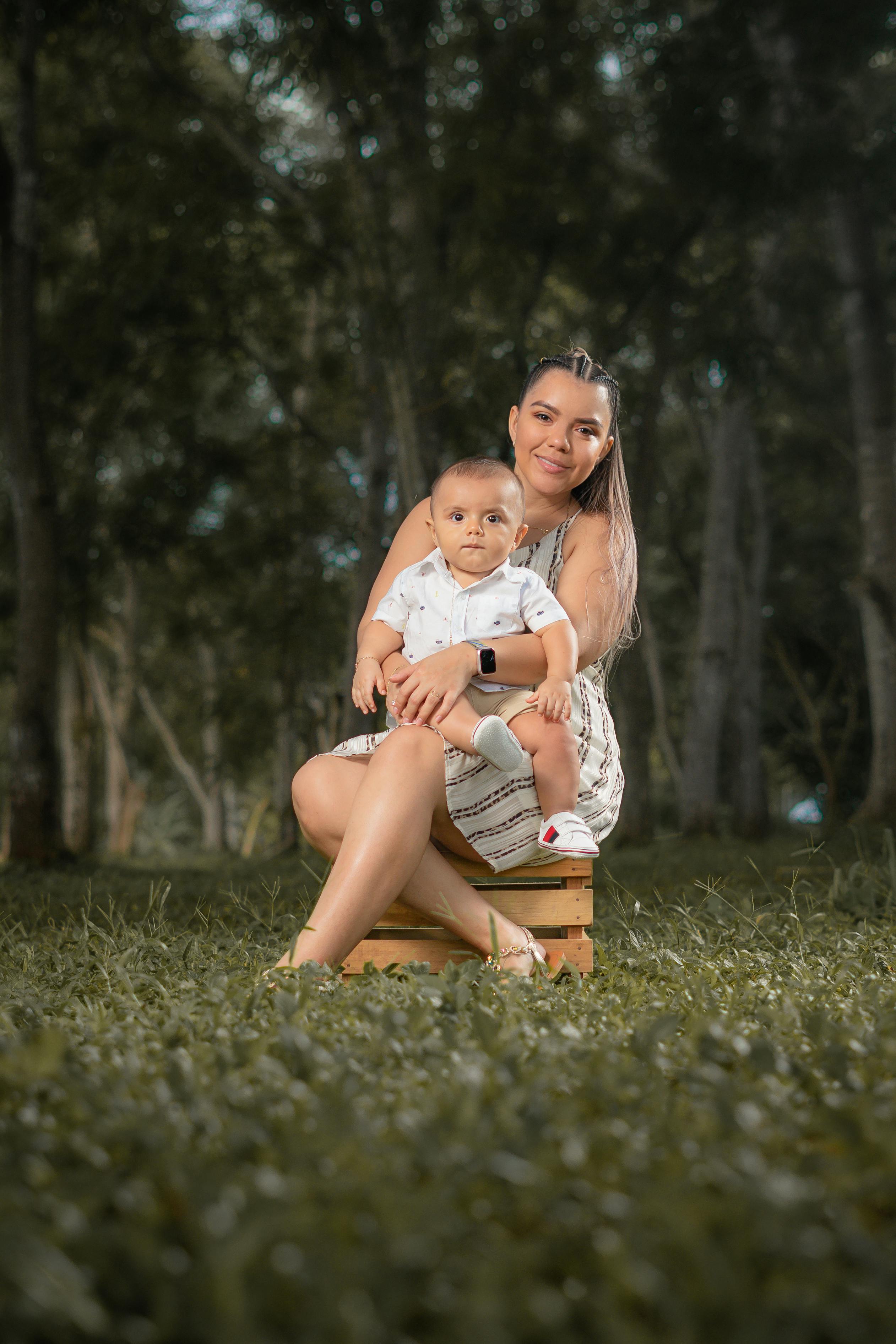 woman sitting with a baby in a park