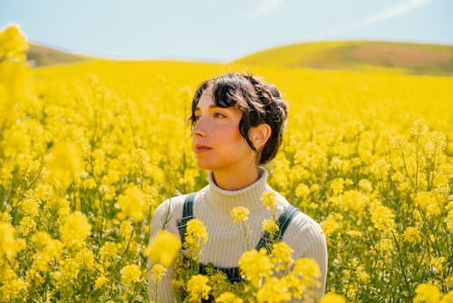 野原の黄色い花に囲まれた女性の肖像