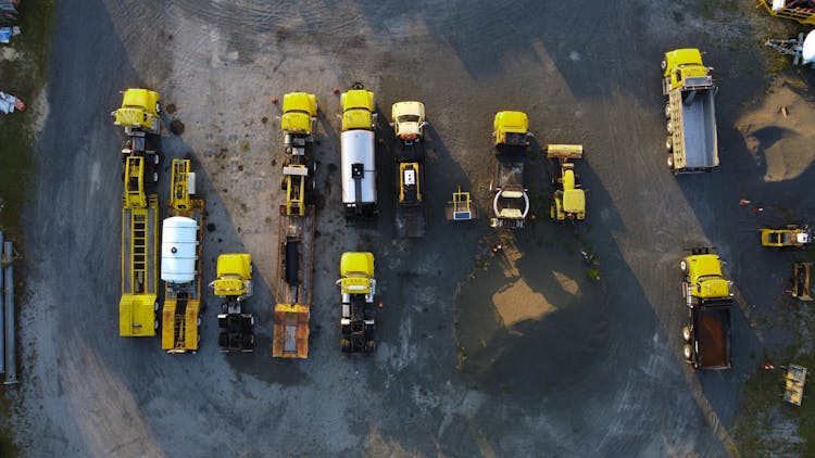 Aerial View Of Yellow Trucks Parked In Rows