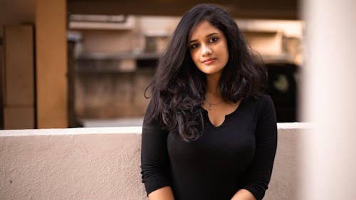 Woman with Black Hair Posing in Black Clothes