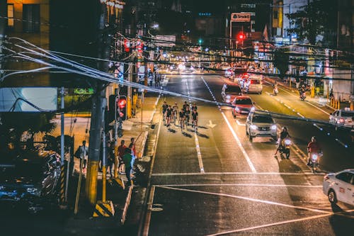 Free People Cycling on Road during Nighttime Stock Photo