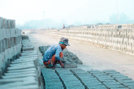 Photo of a Man Working in a Brickyard