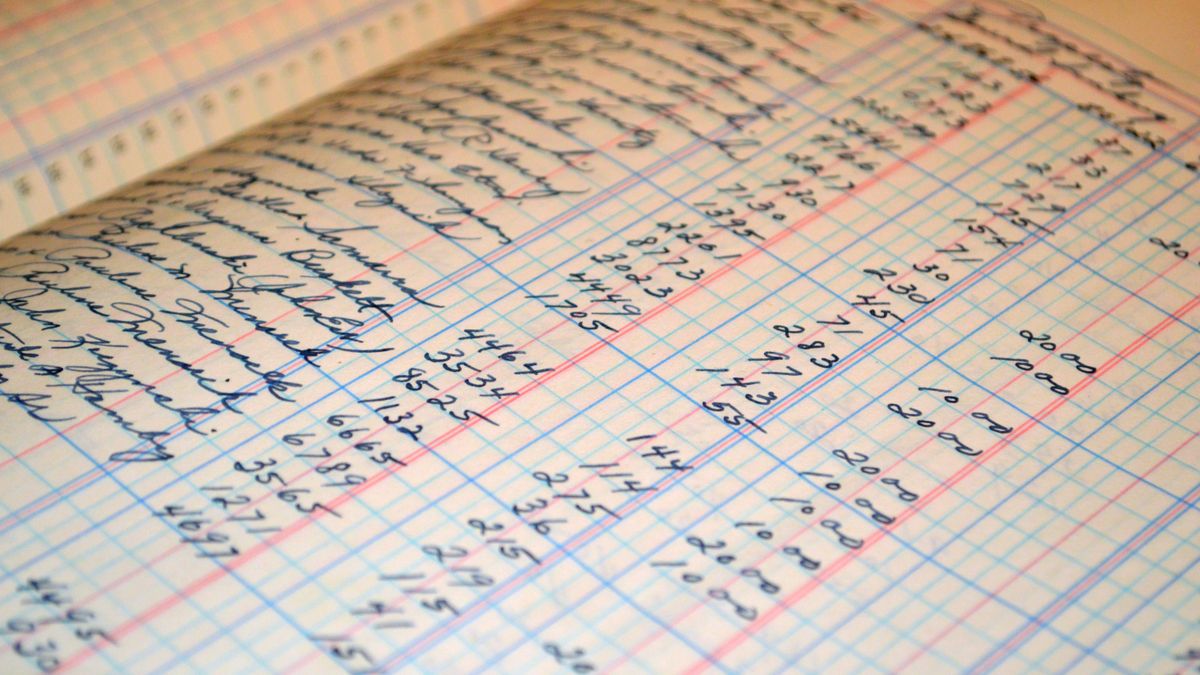 Close-up of a vintage handwritten ledger detailing financial records and accounts.