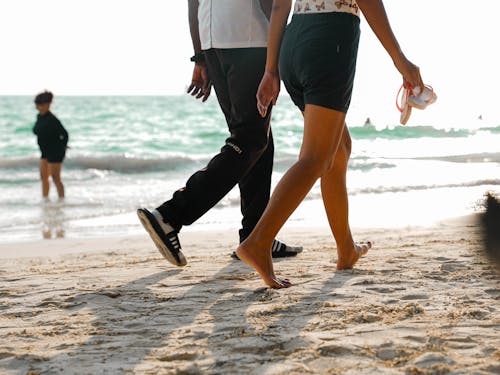 Couple Walking along Sandy Beach