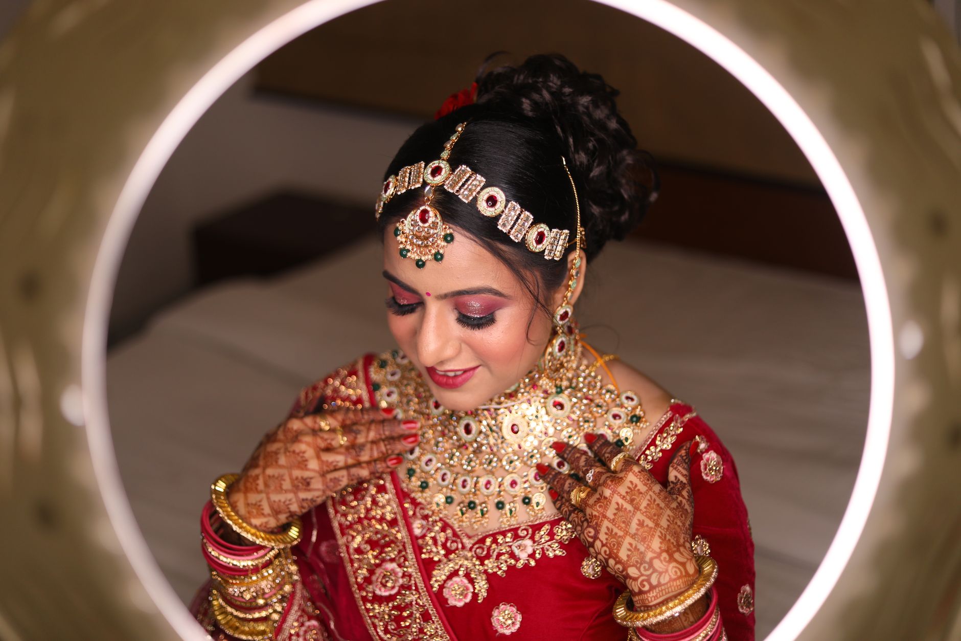 Indian bride adorned in traditional attire and ornate jewelry, reflecting elegance and cultural heritage.