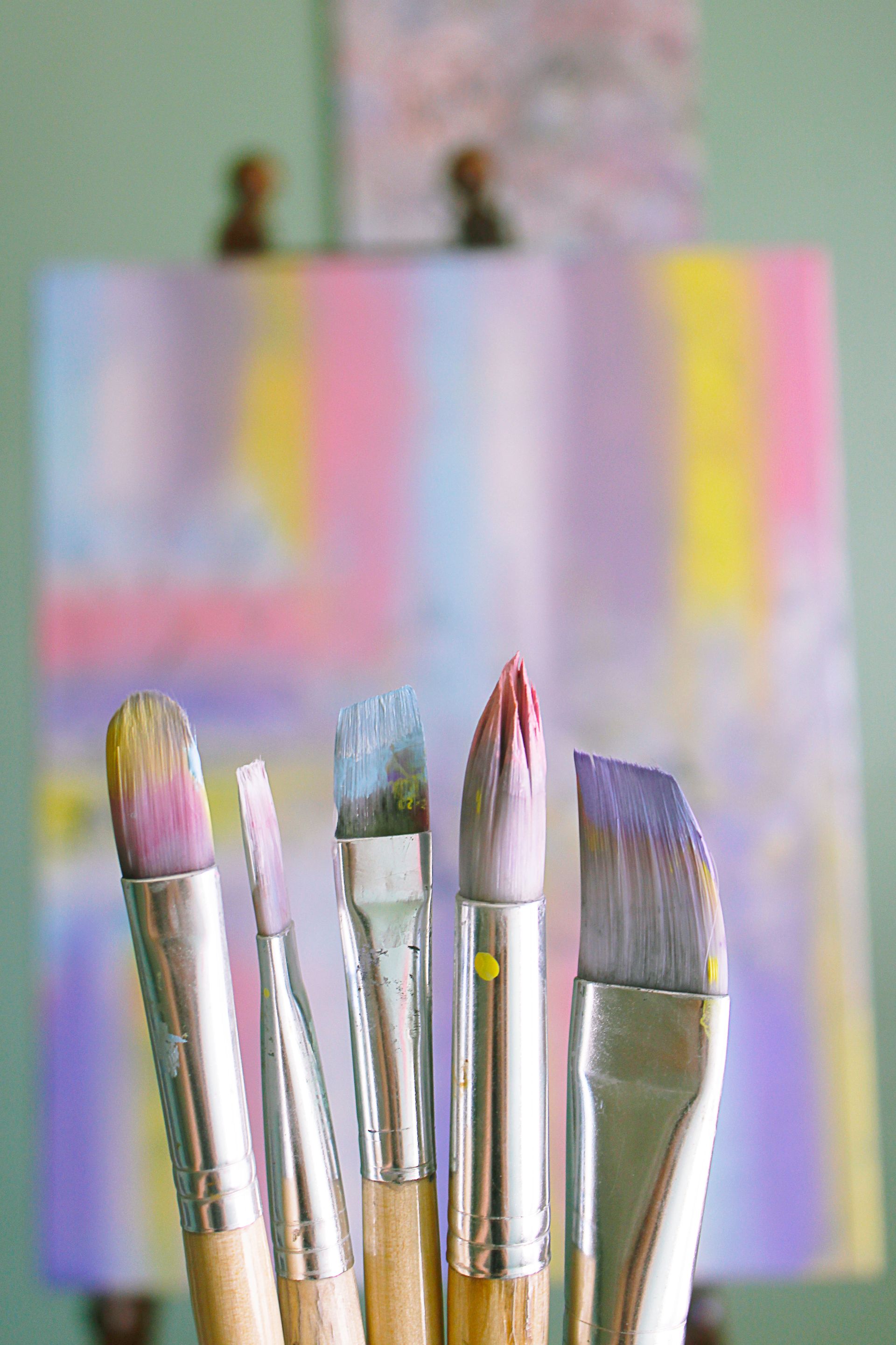 Artist painting on canvas with vibrant colors