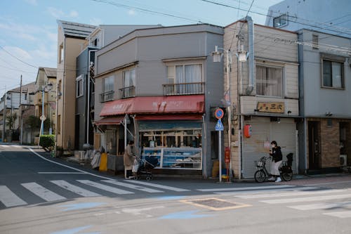 View of Buildings with Shops near an Intersection in City 