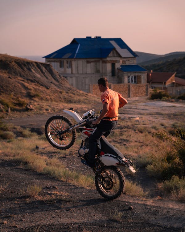 Man Driving on Motorcycle on Dirt Road