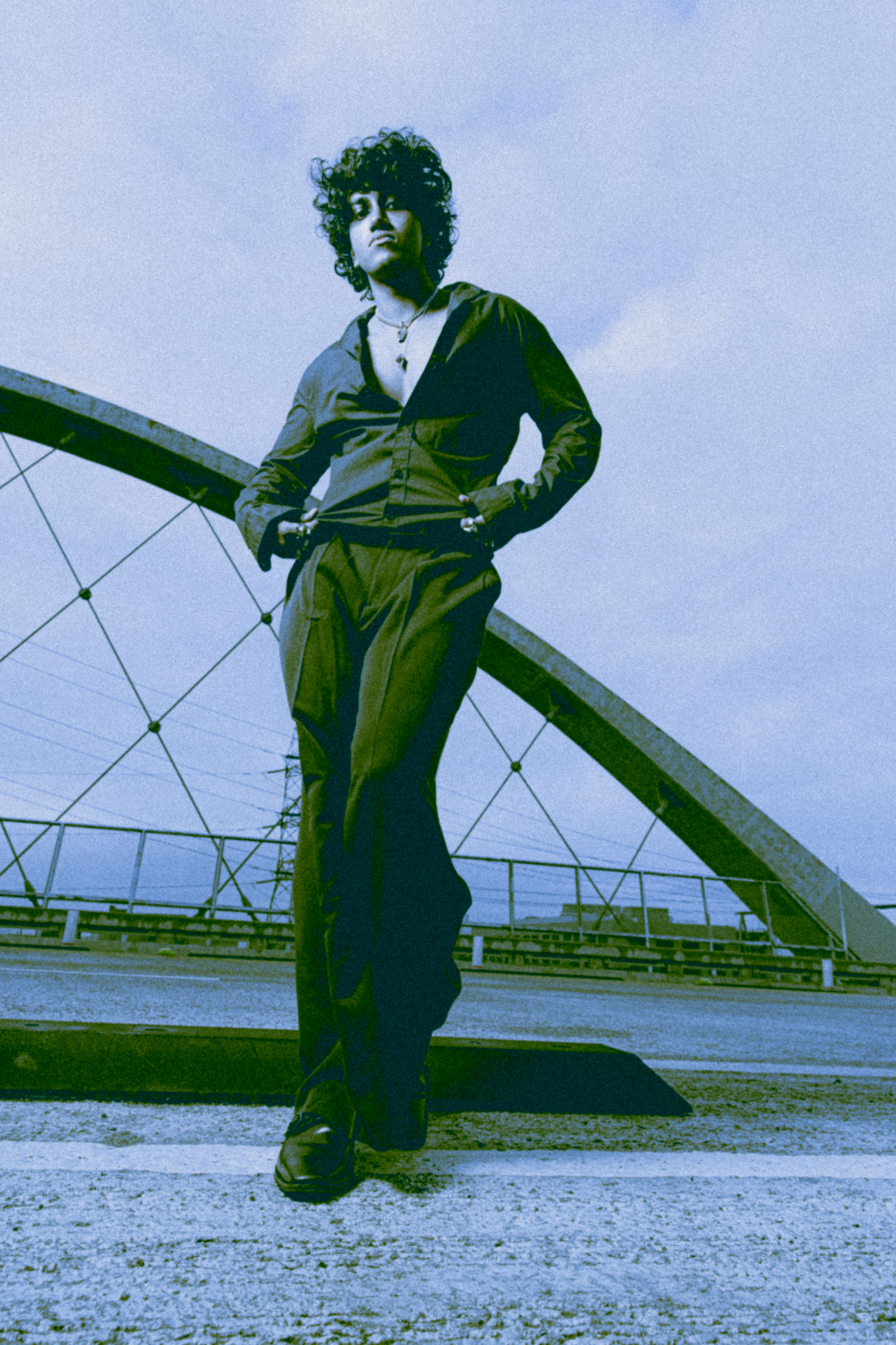 Man Posing near Bridge on City Street · Free Stock Photo