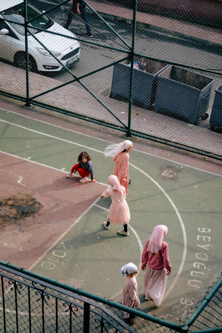 Aerial View Of Girls Playing Basketball On A Court In City 