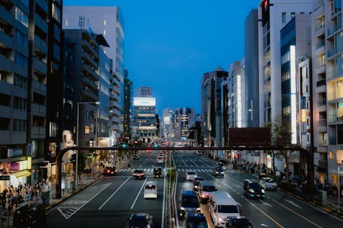 View of a Busy Street between Modern Buildings in City 