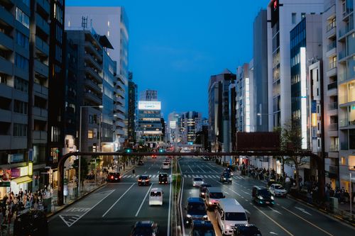 Free Bustling Tokyo street showcasing modern architecture and lively traffic during evening twilight. Stock Photo