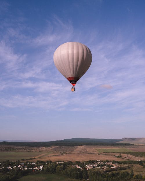 Balloon Flying over Rural Landscape