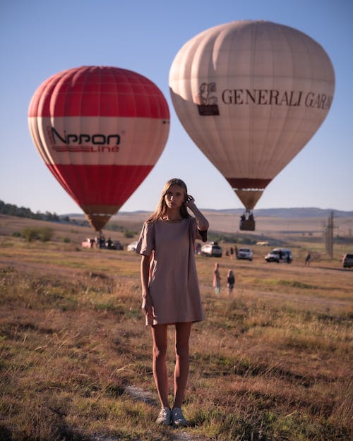 Woman Standing and Posing with Balloons behind