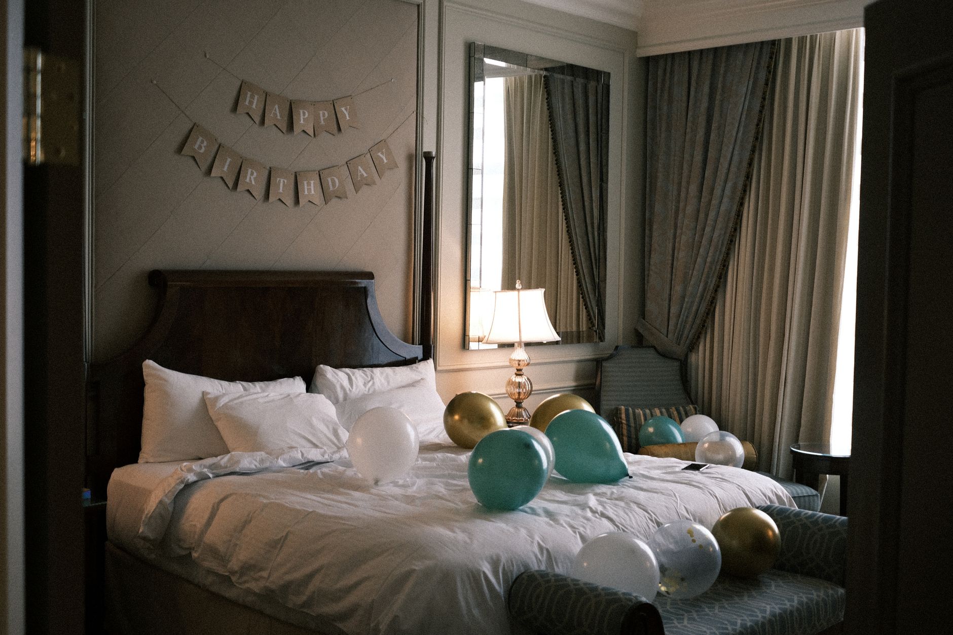 Elegant hotel room decorated with balloons and a 'Happy Birthday' banner, creating a festive atmosphere. Related image for Guest Experience: The Practical Guide for Hotel Teams.