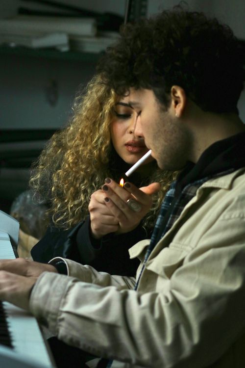 man lighting woman's cigarette Woman Lighting Cigarette for Young Man · Free Stock Photo