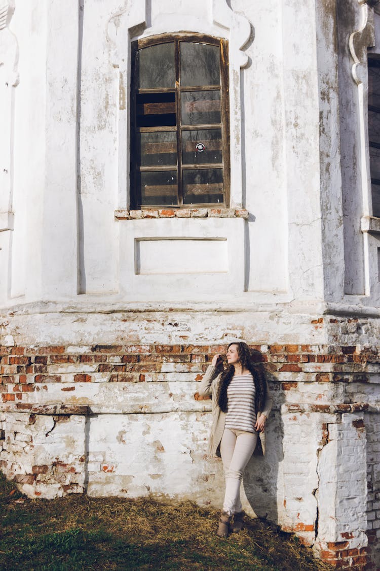 Woman Posing Near Old Brick Building Wall