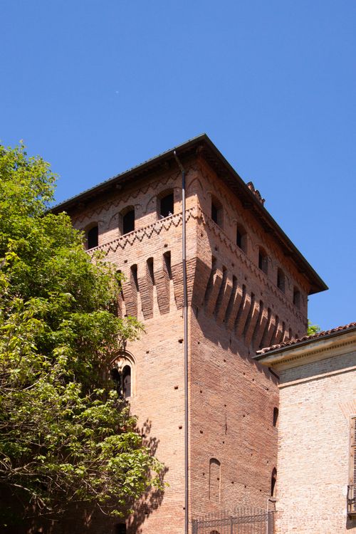 Free Vertical shot of a historical brick tower in Torino, Italy, under a clear blue sky. Stock Photo