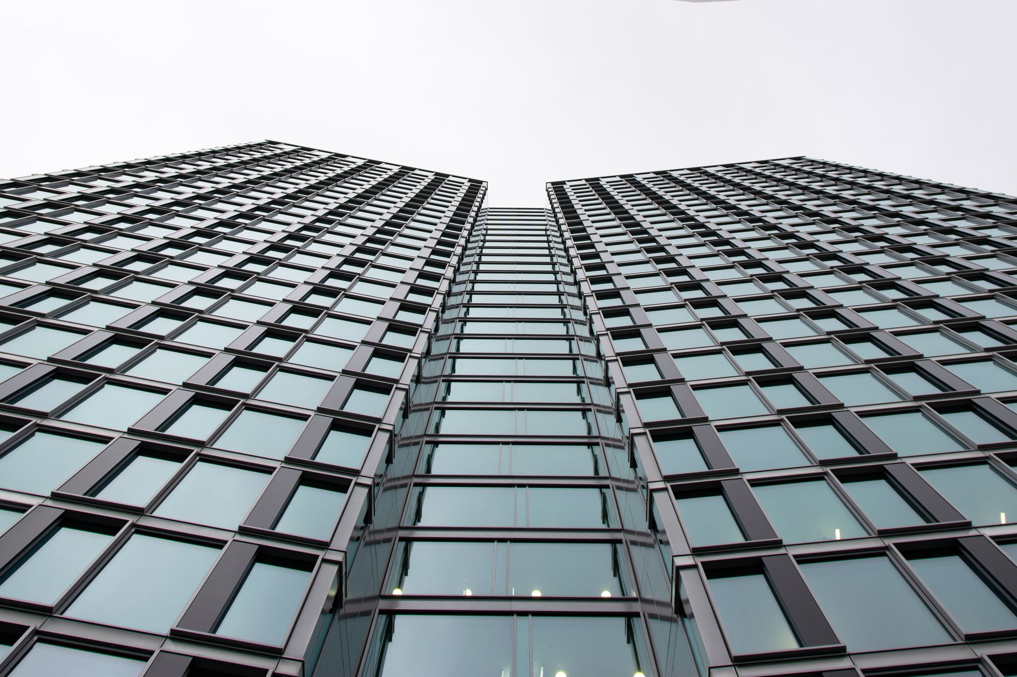 Low angle view of a modern office building with glass facade in Warsaw, Poland.