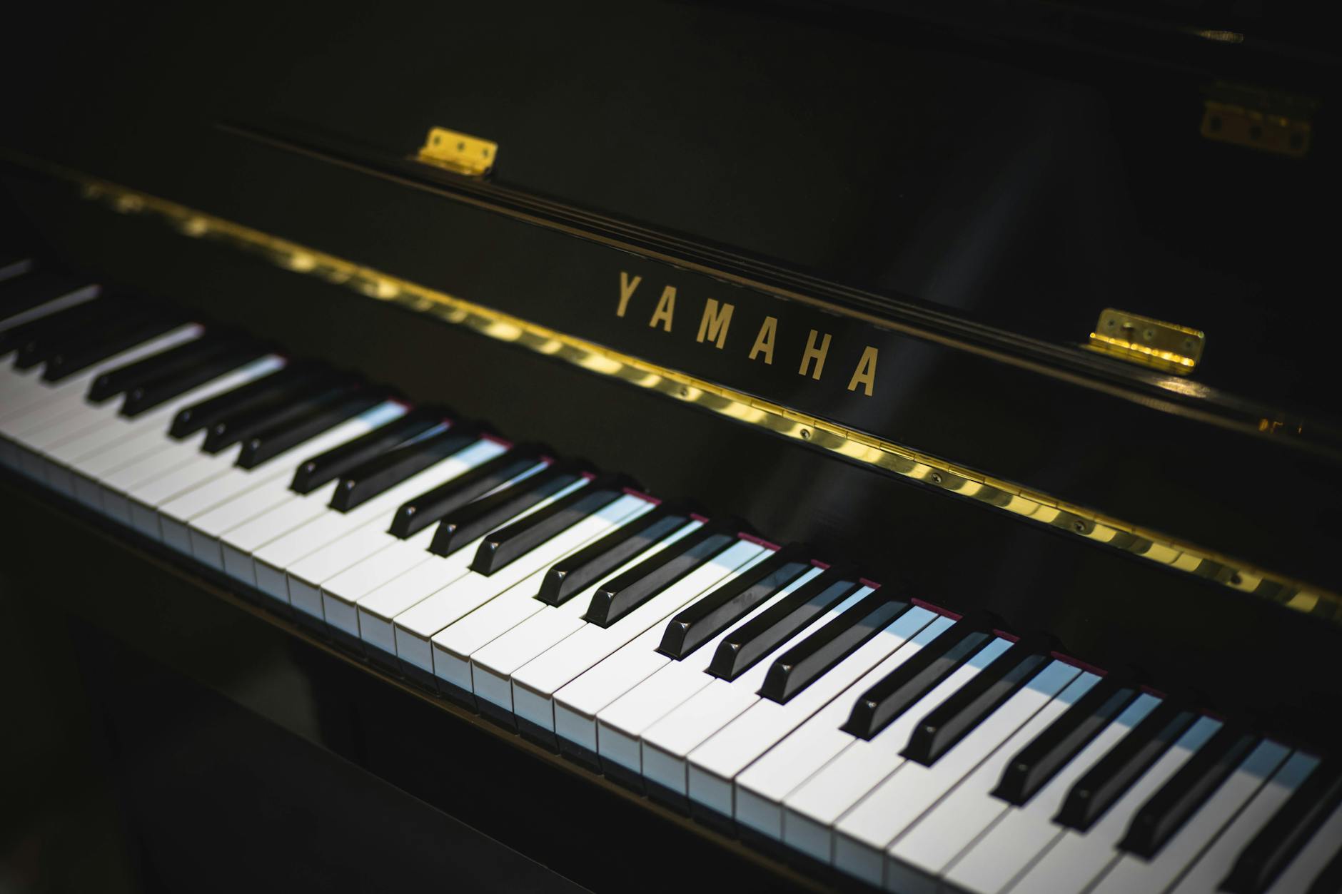 Close-up of a Yamaha piano showing black and white keys, perfect for music enthu